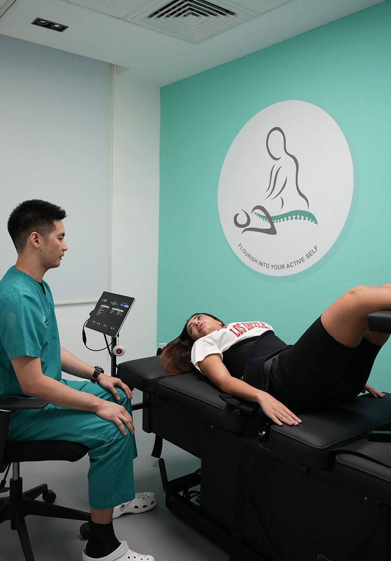 Physiotherapy Decompression Therapy specialist treating a woman's back pain